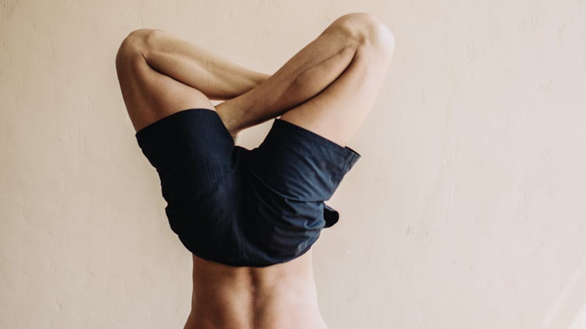 A focused man performing core stabilization exercises in a modern studio.
