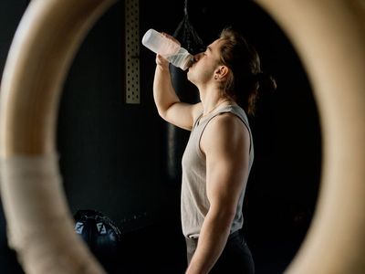 Man drinking water after a successful strength training session.